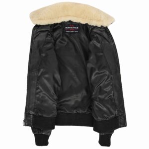 Women's black leather bomber jacket with removable cream shearling collar, front zip closure, ribbed cuffs and hem, utility sleeve pocket, and premium soft leather construction.